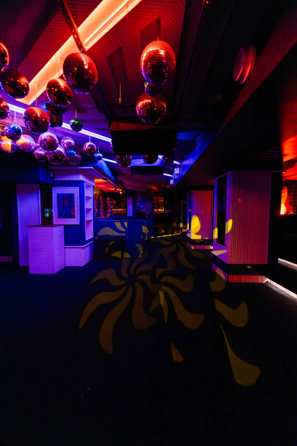 Mirror balls and magenta light over the Pelicano club dancefloor
