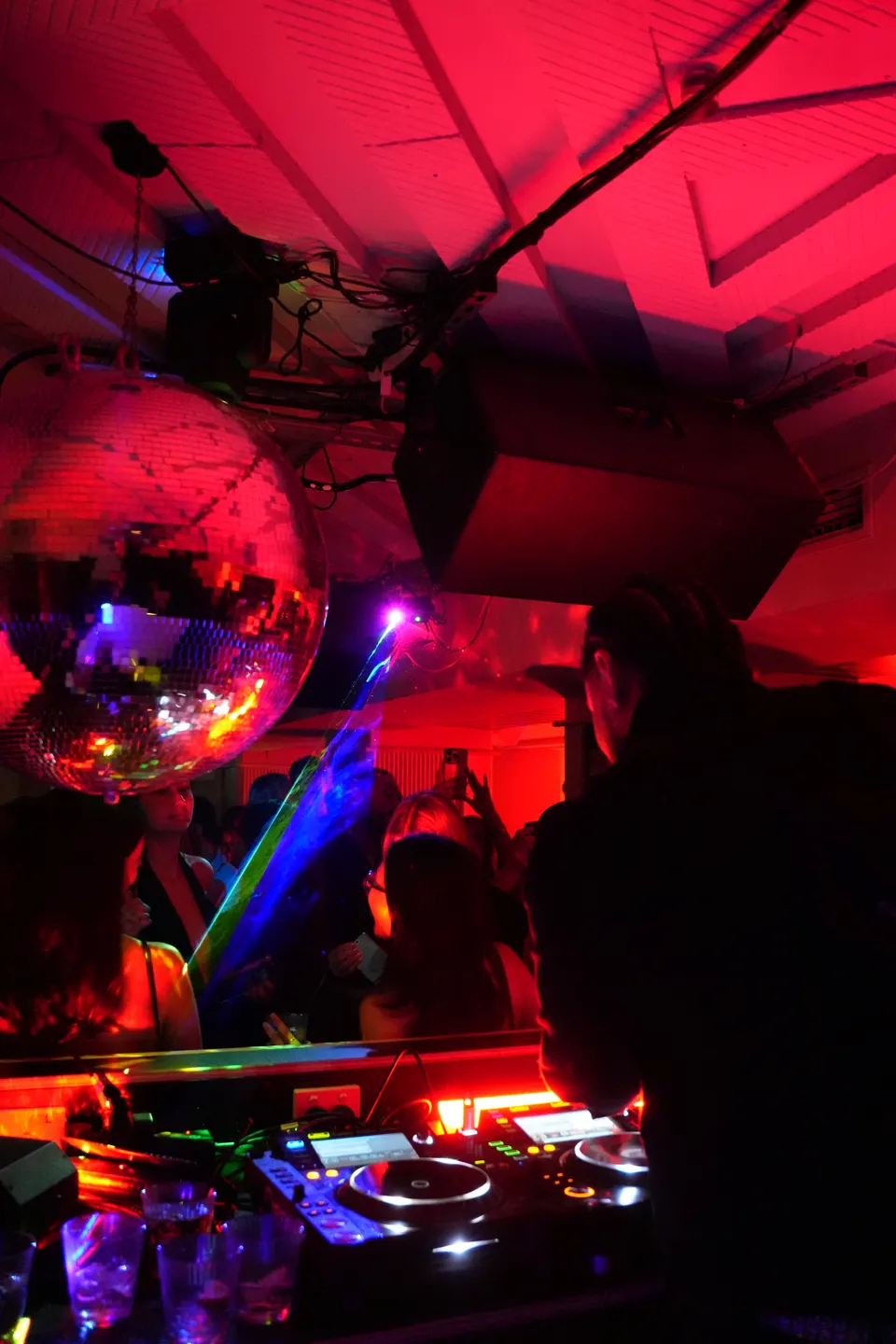 Crowd under a mirror ball in red light