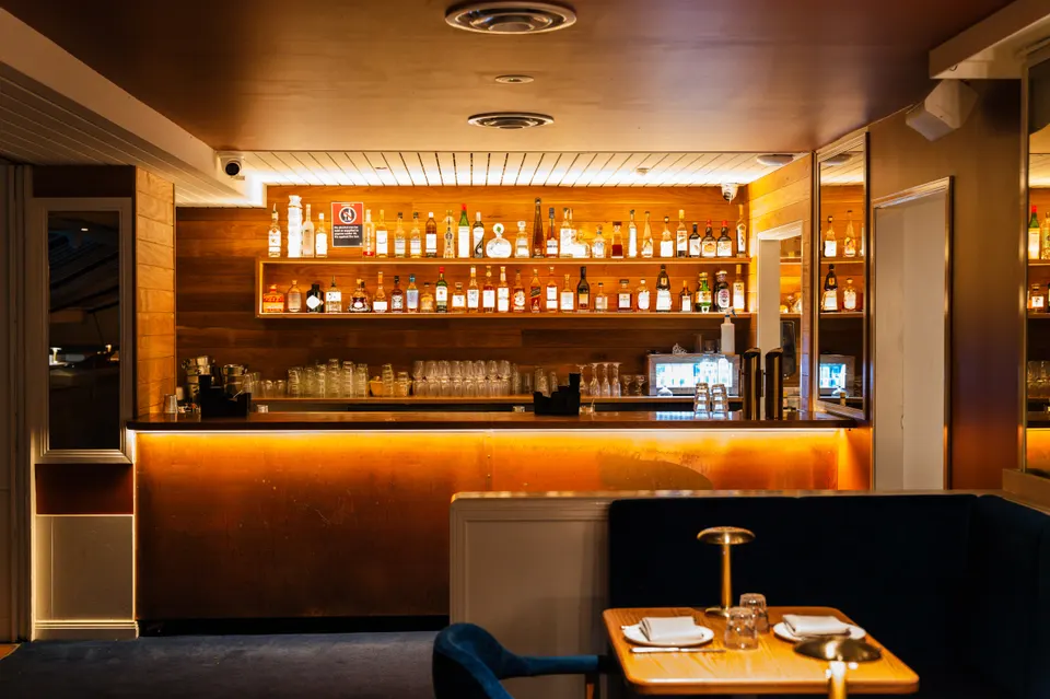 The back bar, lit amber at Pelicano, Potts Point