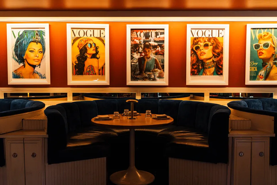 Navy velvet booths beneath a wall of pop-art prints inside the Pelicano restaurant, Potts Point