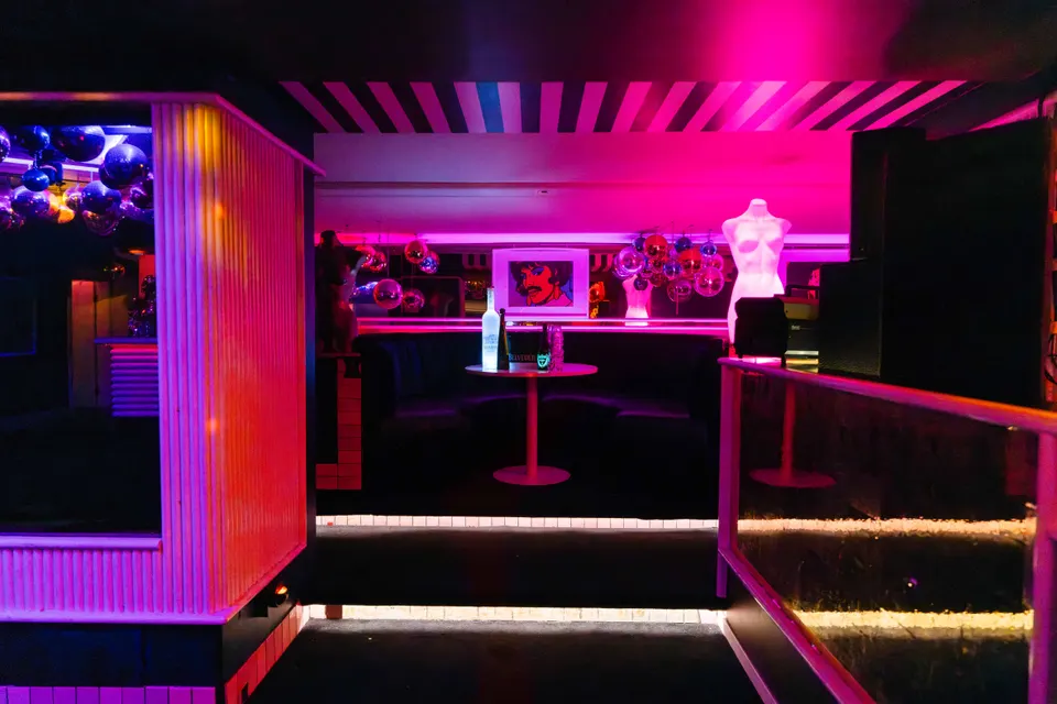 Round navy booth set for dinner under framed pop-art prints